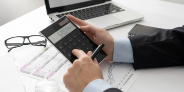 sideways-business-man-calculating-finance-numbers