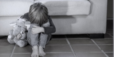 little-boy-outdoors-upset-holding-his-toy