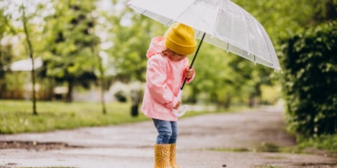 cute-little-girl-jumping-into-puddle-rainy-weather