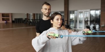patient-doing-physical-rehabilitation-helped-by-therapists
