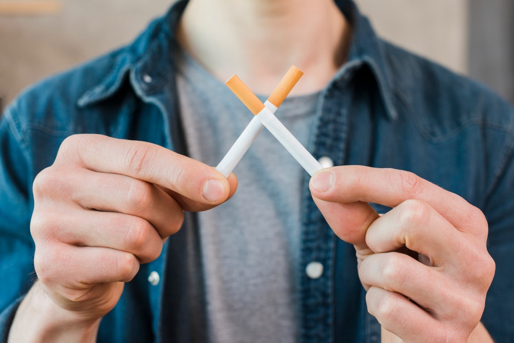 man-s-hand-holding-crossed-cigarettes-1