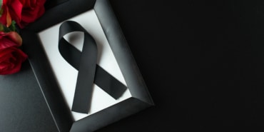 top-view-picture-frame-with-black-bow-dark-wall