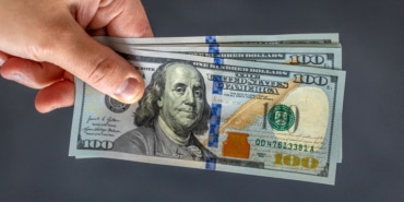 hand-holding-money-international-currency-exchange-world-money