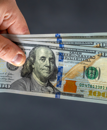hand-holding-money-international-currency-exchange-world-money