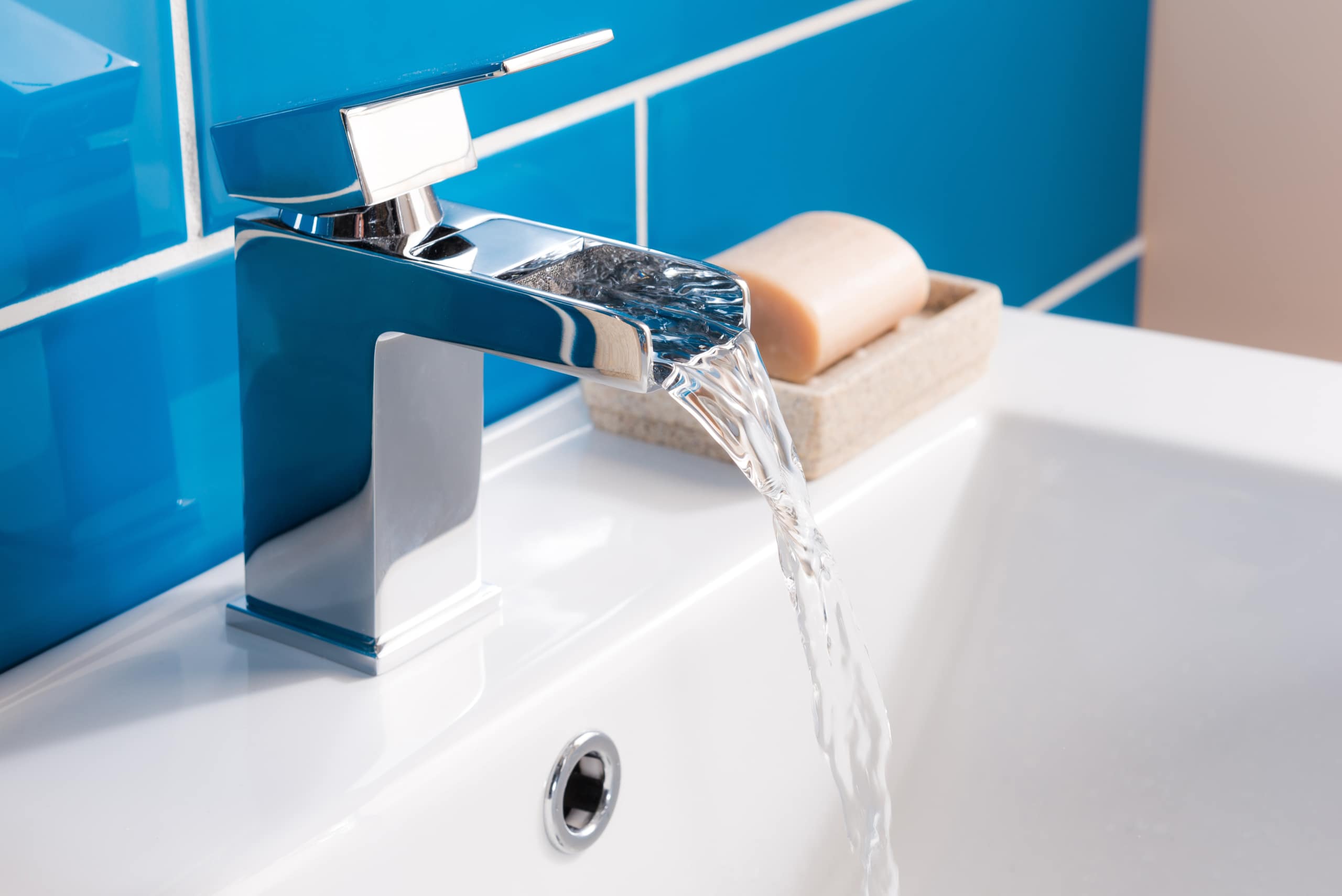 New and modern steel faucet with the ceramic sink in the bathroom