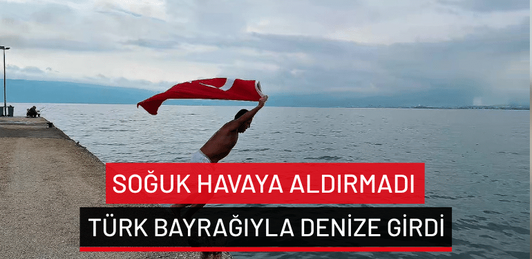 Gemlik’te soğuk havaya aldırmadı… Türk bayrağıyla denize girdi